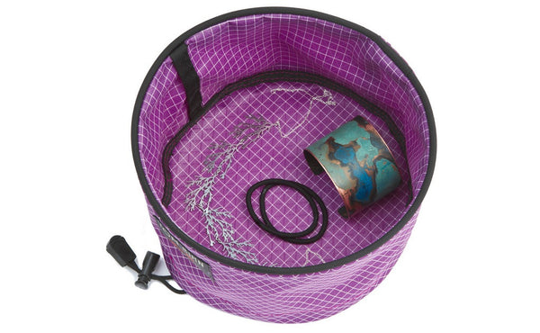A Large Travel Tray in Ultraviolet (purple with white grid) 200 Halcyon easily holding a wrist cuff, some hair ties, and a necklace.